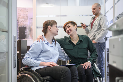 NDIS service provider-businesswomen in wheelchair at the office